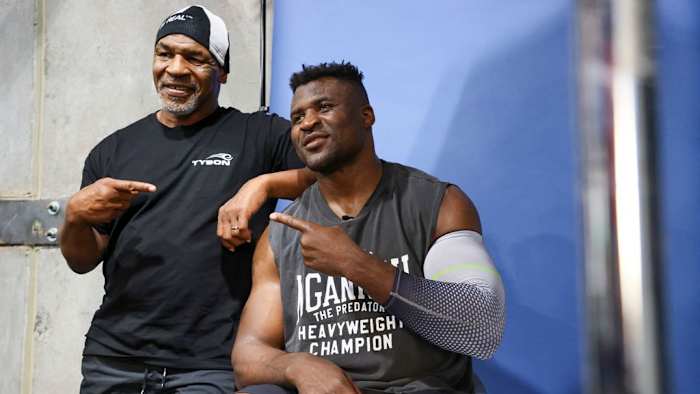 Former US boxer Mike Tyson (L) and Francis Ngannou pose for a photo after a training session at Ngannou's gym in Las Vegas, Nevada, on September 26, 2023. Mixed martial arts star Ngannou will face WBC heavyweight champion Tyson Fury in the boxing ring in Saudi Arabia on October 28. IAN MAULE/AFP VIA GETTY IMAGES.